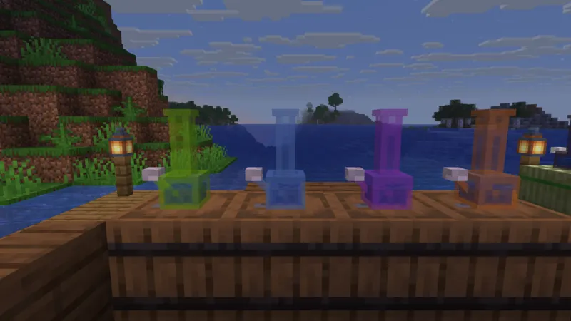 Four colored glass bongs standing on a table at the end of a jetty at dusk, lanterns on either side.