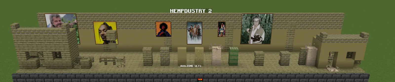 Two small hemp-plank houses flank a row of building blocks, hempcrete, bricks, planks, wool and bales, under a hemp-brick wall hung with the mod's paintings.